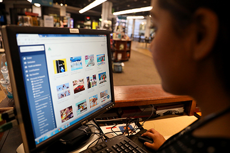 A person looking at the benefits available to MSU Denver community members.