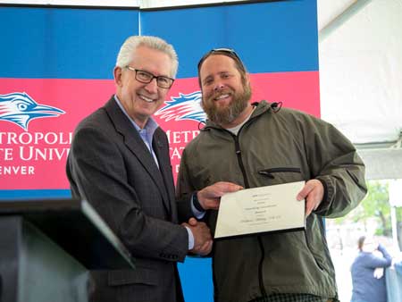 Stephen Jordan presents Matt Makley, Ph.D., with a Teaching Excellence Award at MSU Denver