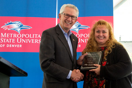 LoriAnn Garcia receives a Distinguished Service Award from President Stephen Jordan at the 2017 Faculty Staff Appreciation Barbecue. 