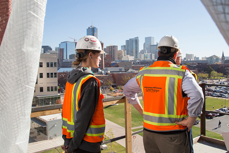 Construction visitors view the campus and downtown Denver from the top of the new Aerospace and Engineering Sciences Building, which is a palpable example of the University building its brand through public-private partnerships and supplying local industries with a specialized college-educated workforce.