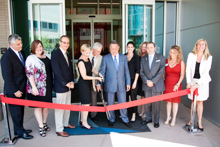 An estimated 200 people, including President Stephen Jordan (center, in light sports coat) attended the ribbon cutting for the SpringHill Suites on Aug. 8, 2012. The hotel and its management company, Sage Hospitality, provide hands-on experience for students, who work alongside professionals.