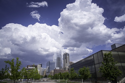 Denver downtown with large, white clouds.