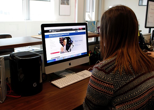 Woman sitting at computer.