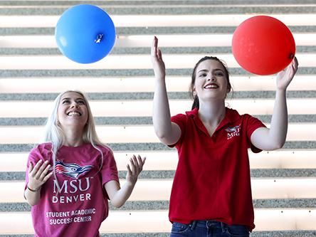 two MSU Denver students catching balloons