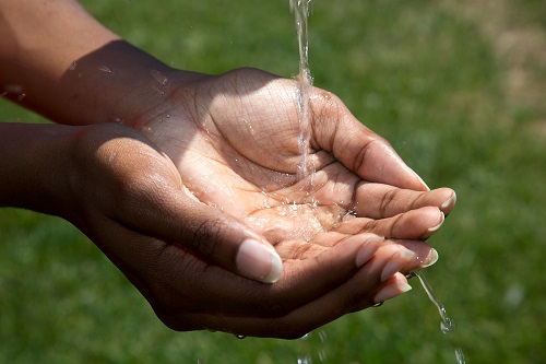 Photo of water pouring into hands