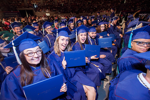 Grads with their diplomas