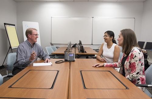 Colleagues sitting around table