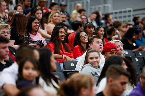 Students sitting in bleachers during convocation.