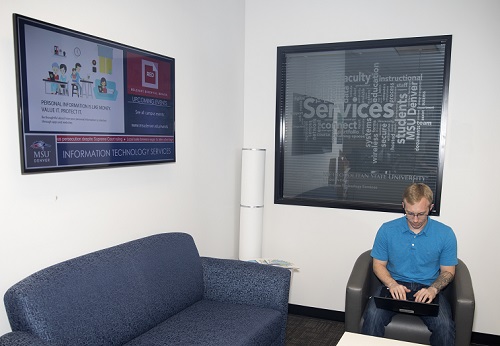 ITS employee in ITS lobby working on computer