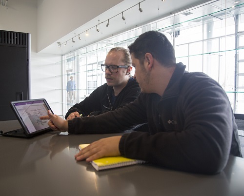 Students at desk looking at computer