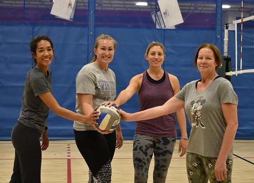 Four MSU Denver employees playing volleyball