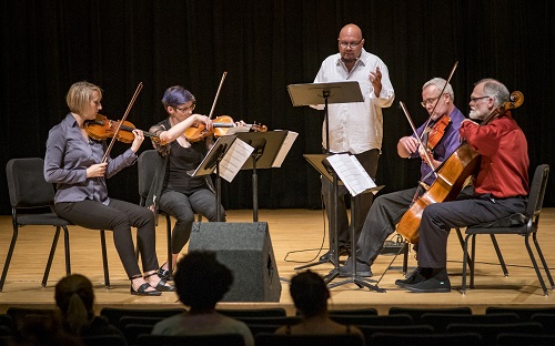 Quintet performing on stage