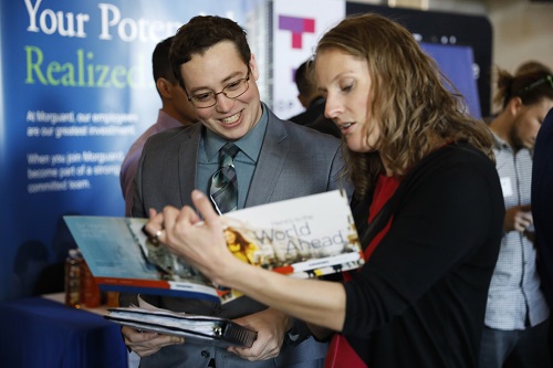 Students looking at job fair materials