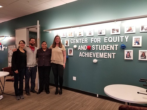 CESA staff members in office in front of sign