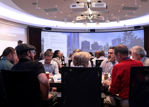 Strategic plan committee members sitting around a table at Vision Conference.