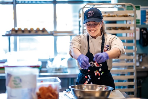 Hospitality student in kitchen.