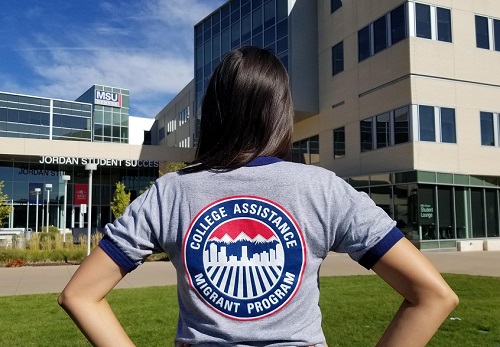 Student standing in front of JSSB and wearing CAMP shirt.