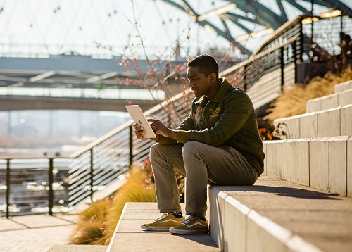 Anthony Baker working on laptop in Confluence park.