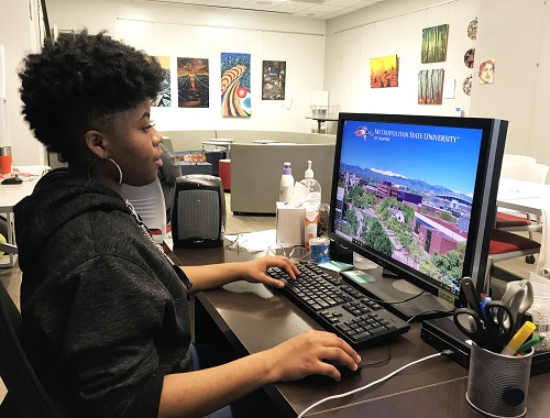 Sauntice Washington working on a laptop computer.