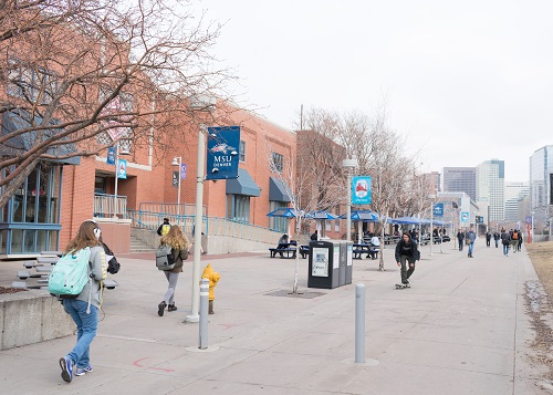 Students walking near Tivoli Student Union during fall.